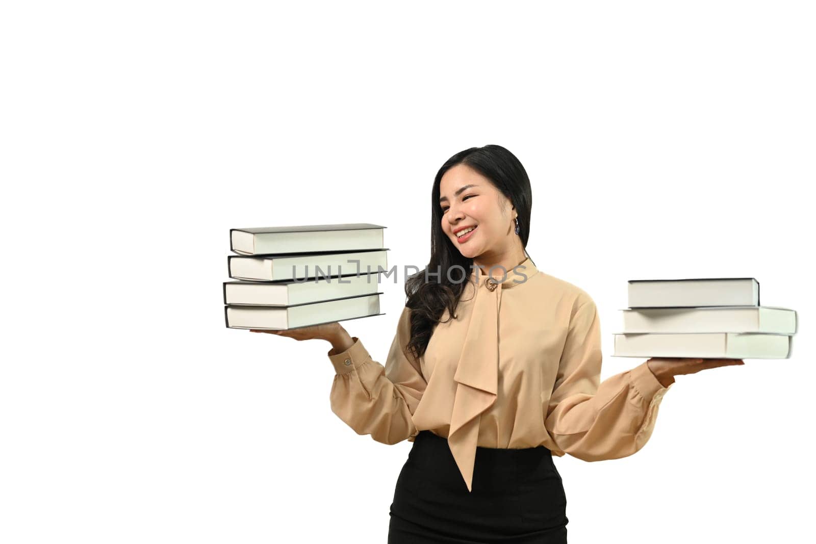 Portrait of happy young woman holding pile of books standing isolated on white background. Education concept.