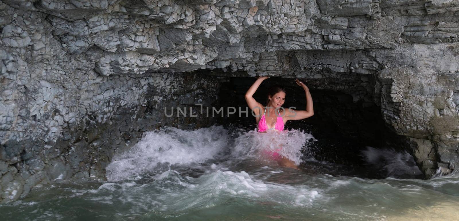 Woman travel sea. Happy tourist in pink bikini enjoy taking picture outdoors for memories. Woman traveler posing on the beach at sea surrounded by volcanic mountains, sharing travel adventure journey by panophotograph