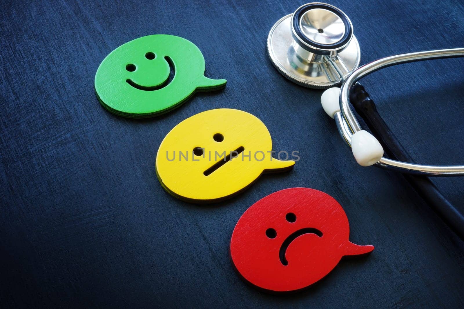 Stethoscope and emoji as a symbol of evaluation. Patient experience concept. by designer491