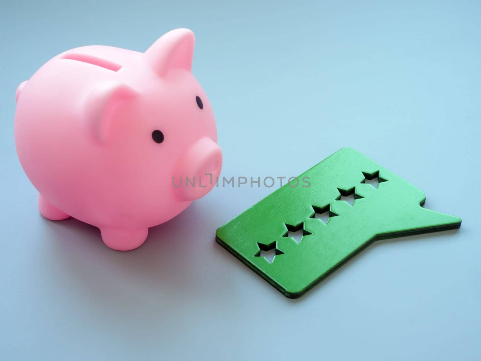Pink piggy bank and five stars for review. by designer491