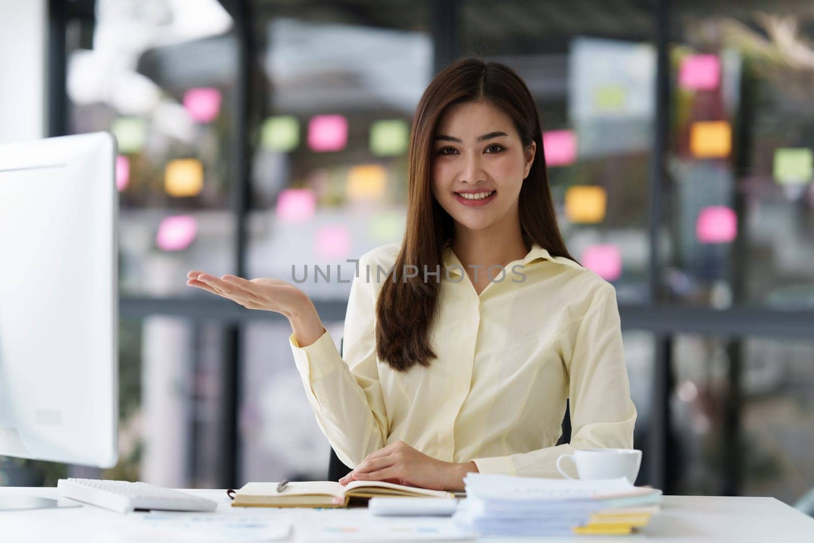 Beautiful Asian Banker or Accountant makes financial report and tax, analyzes profits. Accountant checks status of financial by itchaznong