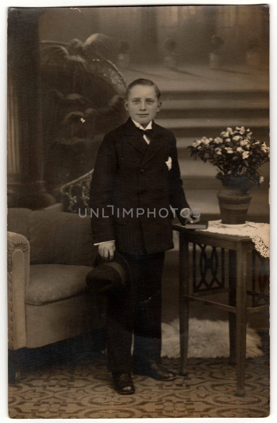 PRAGUE, THE CZECHOSLOVAK REPUBLIC - CIRCA 1920s: Vintage photo shows man poses in an elegant room. Black and white photography with sepia effect.