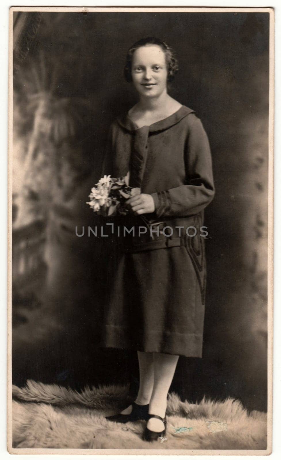 HEJNICE - HAINDORF, THE CZECHOSLOVAK REPUBLIC - CIRCA 1920s: Vintage photo shows woman poses in a photography studio. Retro black and white studio photography.