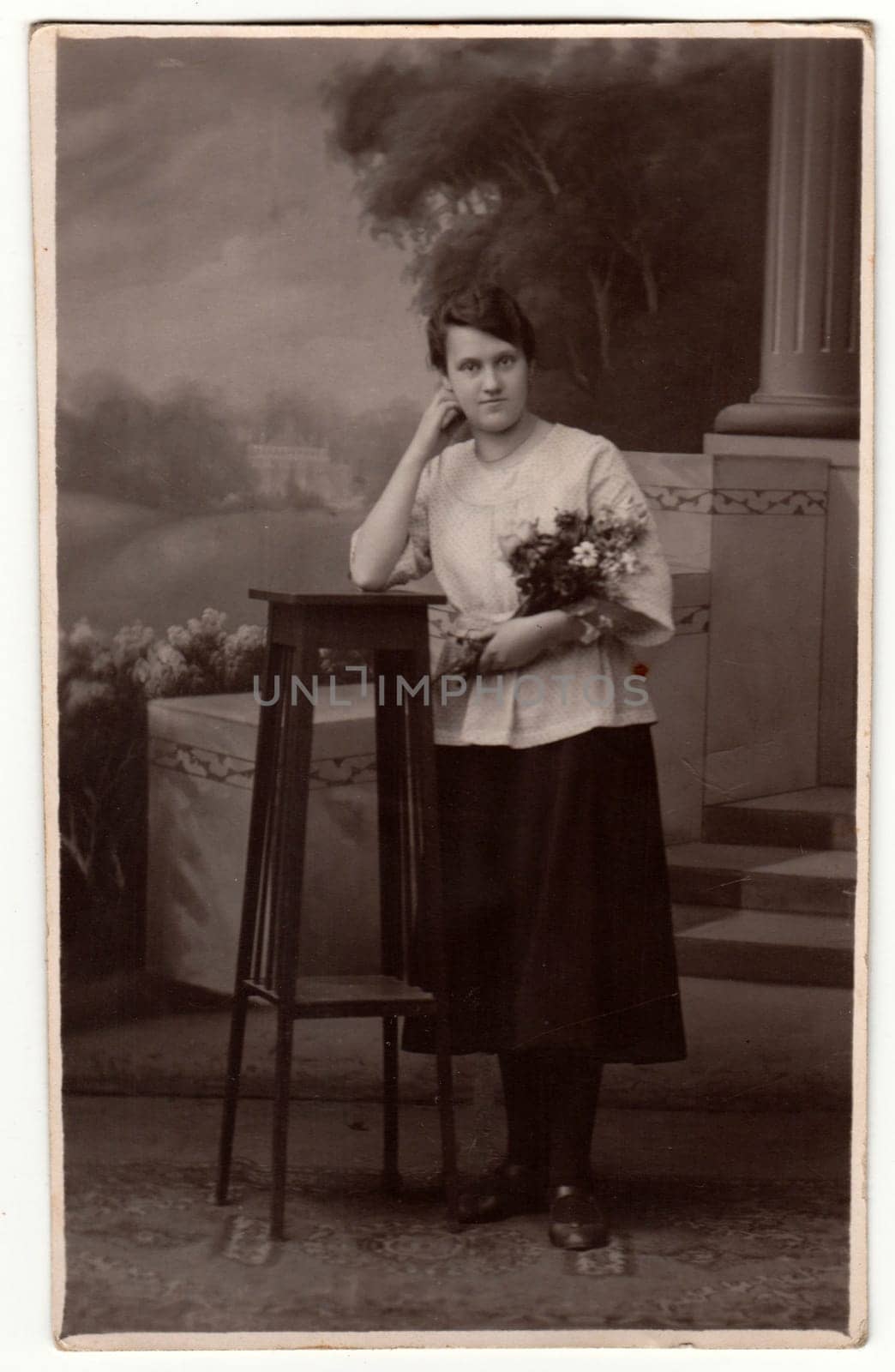 Vintage photo shows woman in a photography studio. Retro black and white studio photography with sepia effect. by roman_nerud