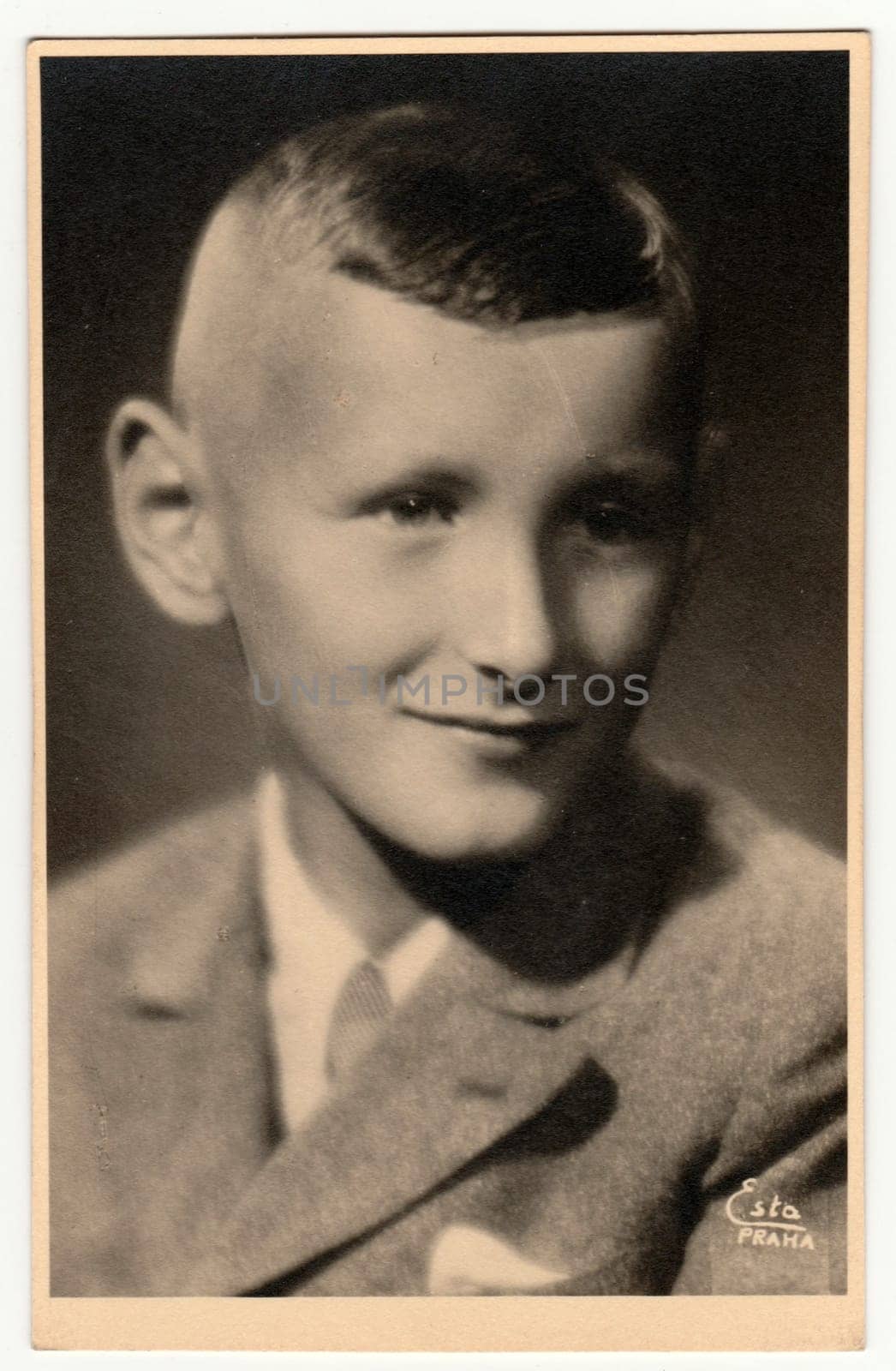 Vintage photo shows a young boy - portrait in a photography studio. Retro black and white studio photography with sepia effect. by roman_nerud