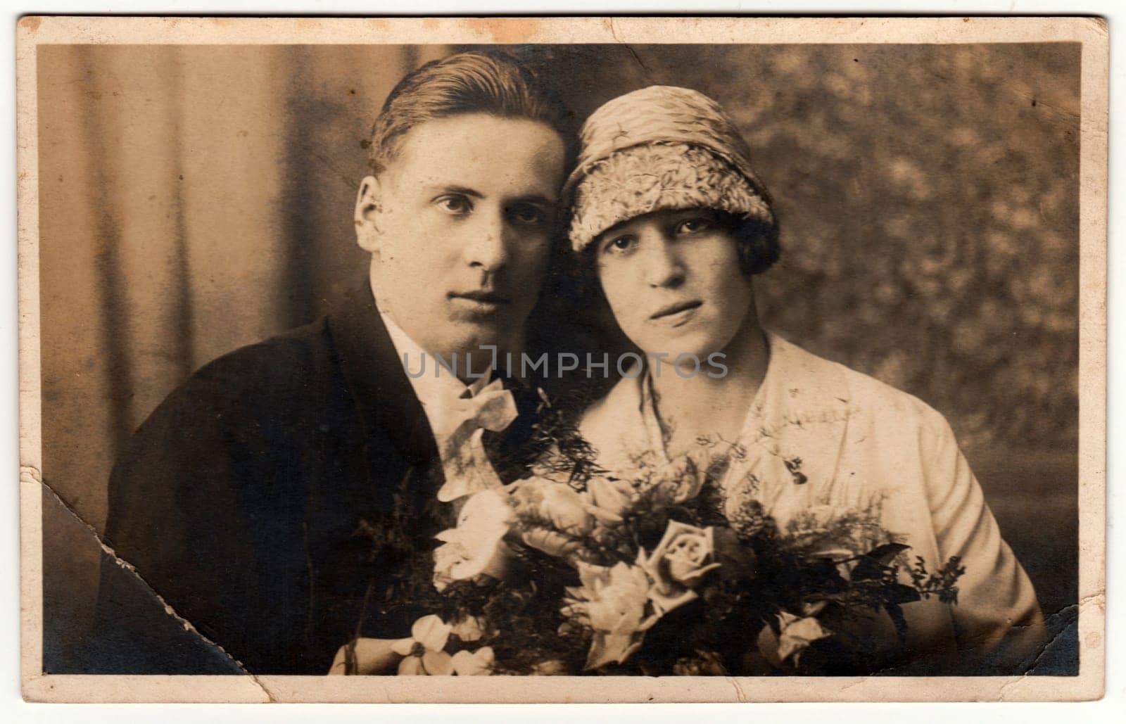 THE CZECHOSLOVAK REPUBLIC - CIRCA 1930s: Vintage photo shows newlyweds. Wedding ceremony - bride and groom. Bride holds wedding flowers. Retro black and white photography.