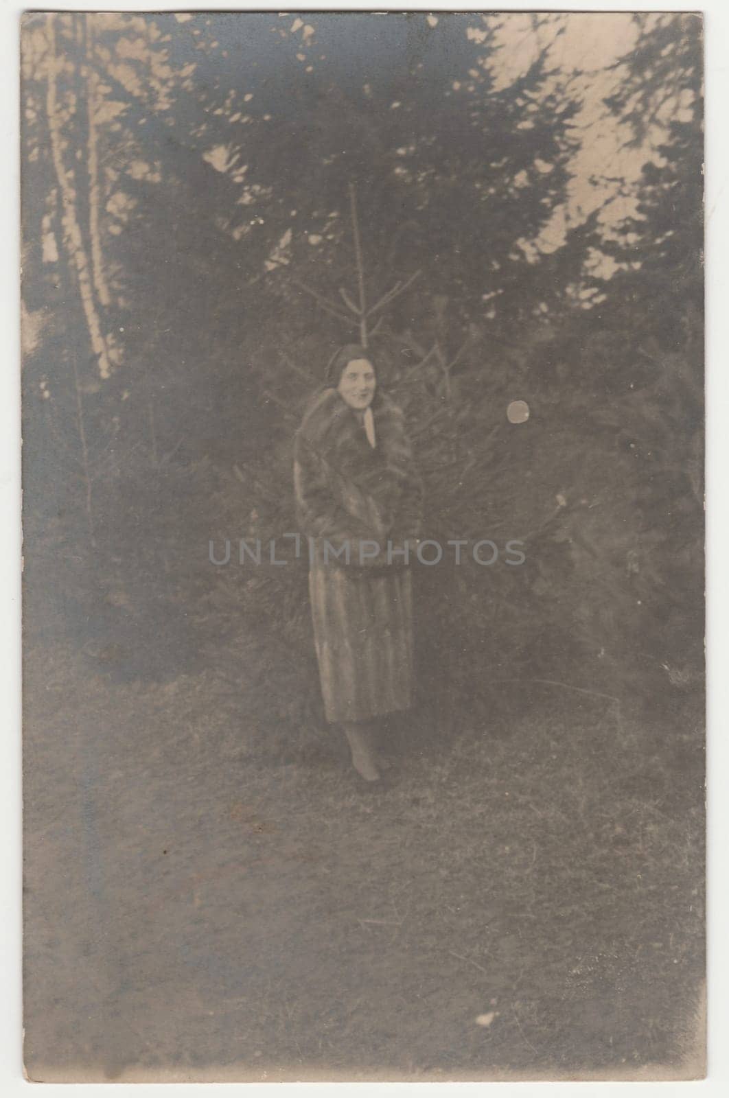 THE CZECHOSLOVAK REPUBLIC - 1931: Vintage photo shows woman in a winter time. Woman wears a fur coat Retro black and white photography.