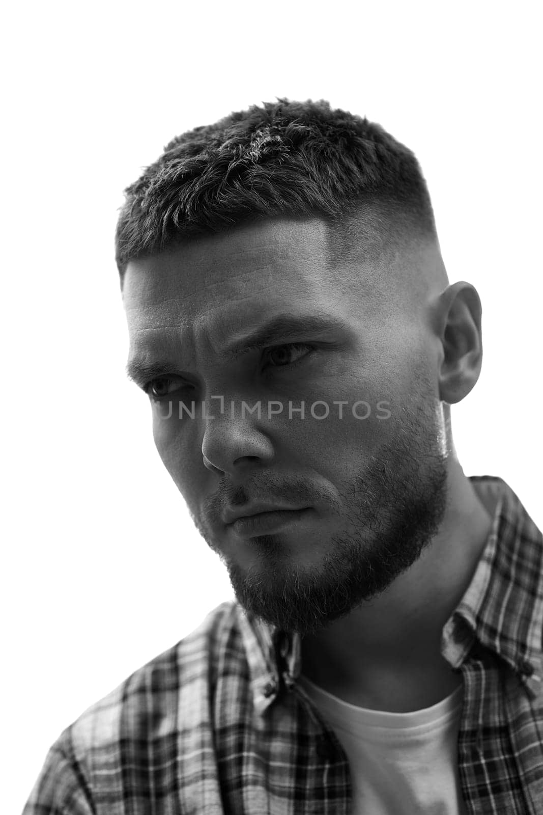 young man with stylish hair and beard on white background. black and white