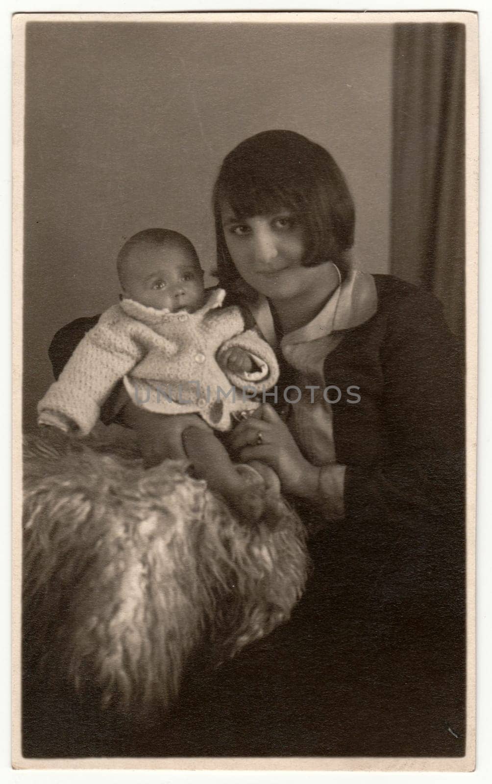 THE CZECHOSLOVAK REPUBLIC - CIRCA 1930s: Vintage photo shows woman with baby - newborn. Retro black and white studio photography.