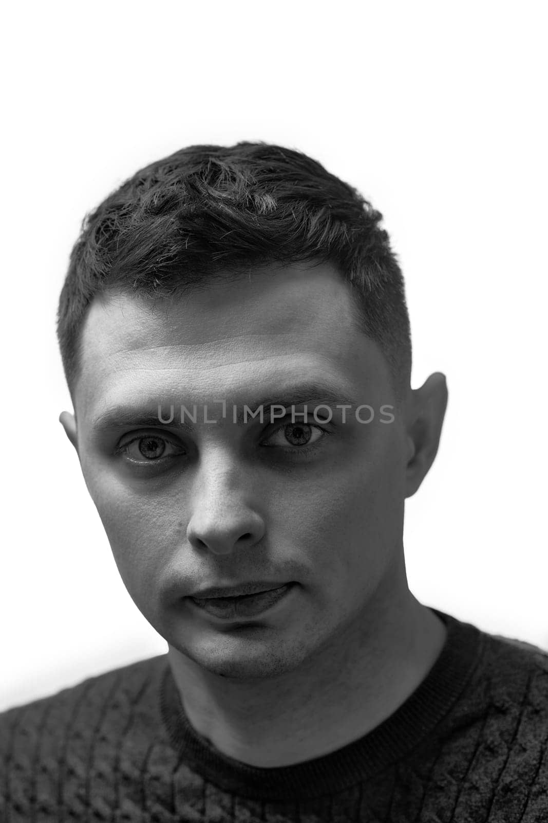 young man with stylish hair and beard looking at camera on white background