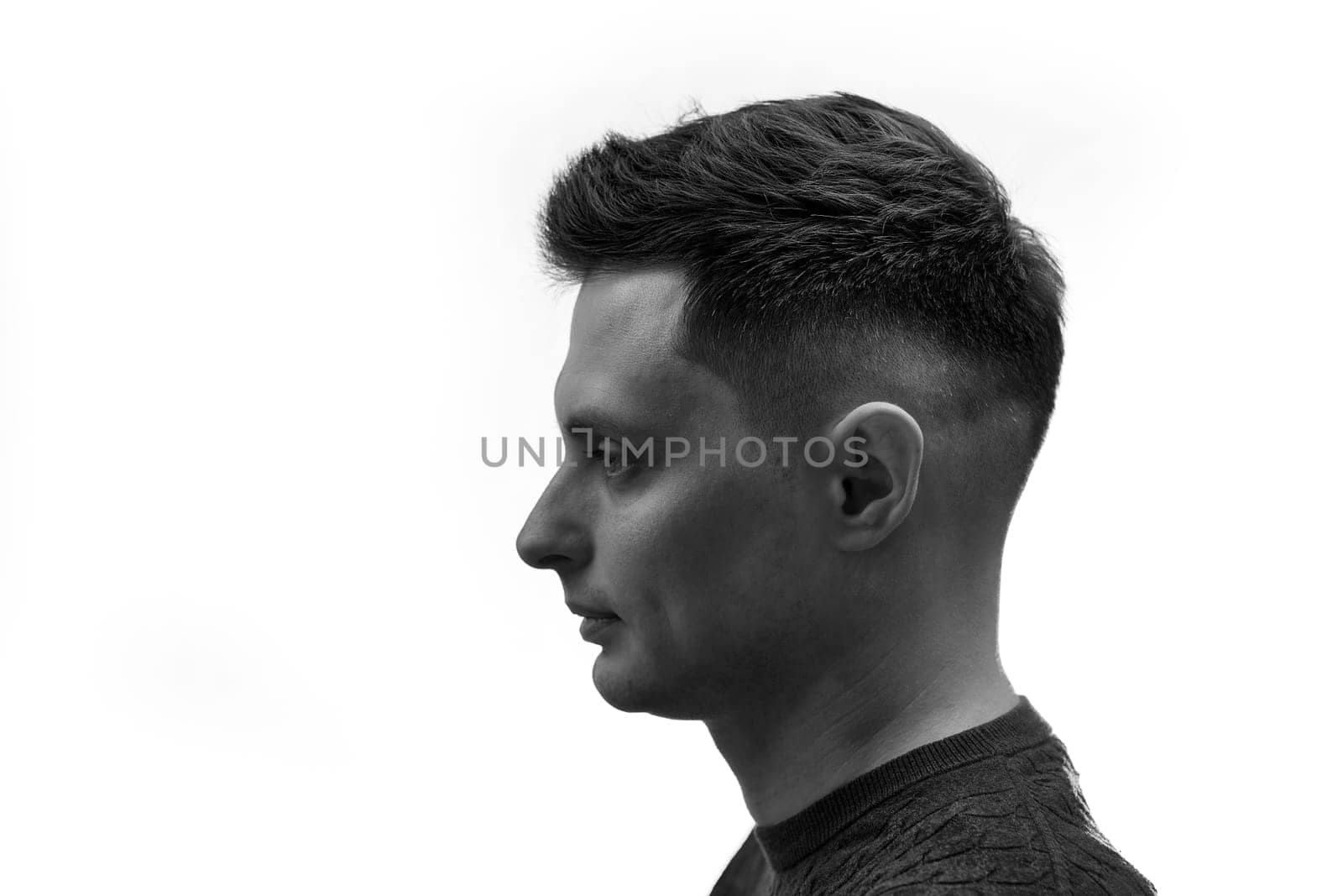 side view of man with stylish hair and beard on white background