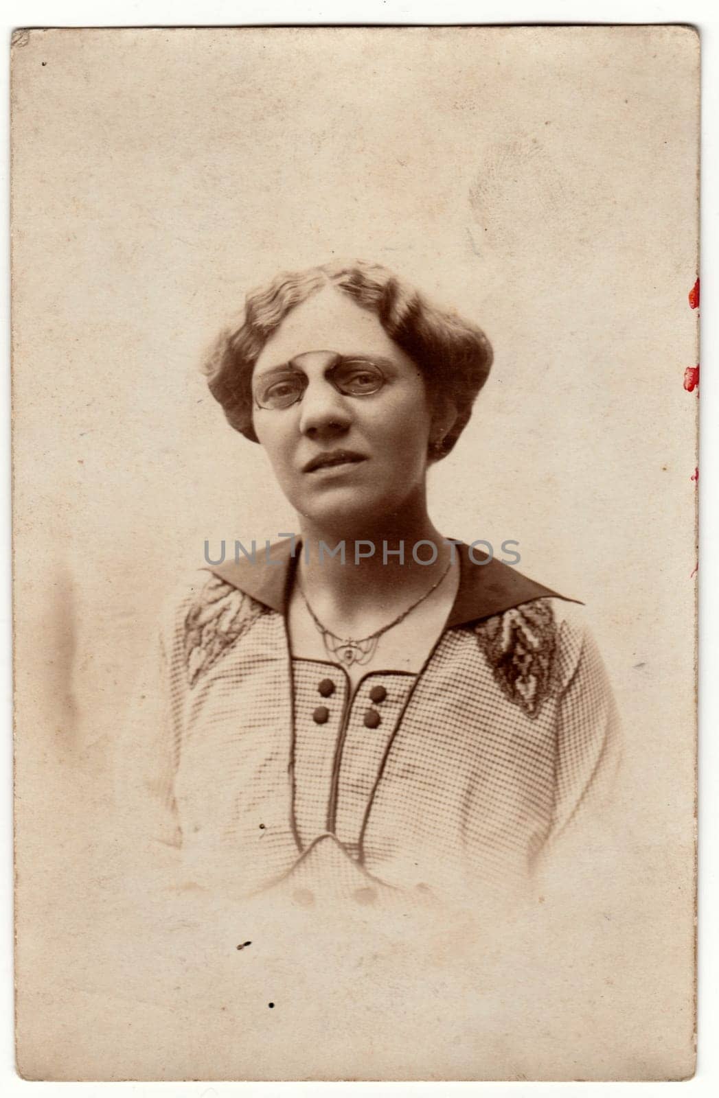 Vintage photo shows a mature woman wears vintage antique nose clip glasses. Retro black and white photography. Photo was taken in Austro-Hungarian Empire or also Austro-Hungarian Monarchy. Circa 1920s. by roman_nerud