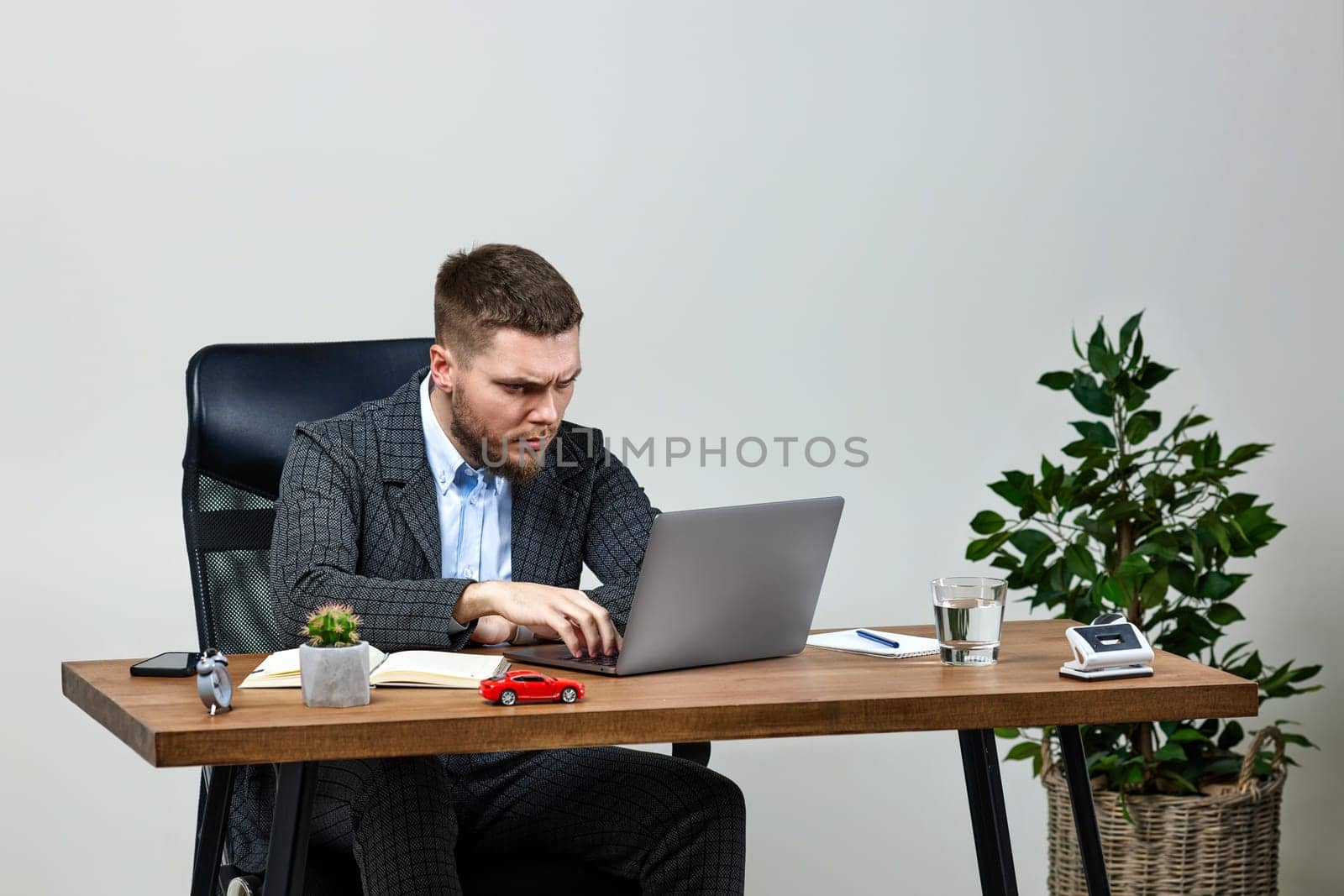 young bearded man thinks about successful financial ideas sitting at desk