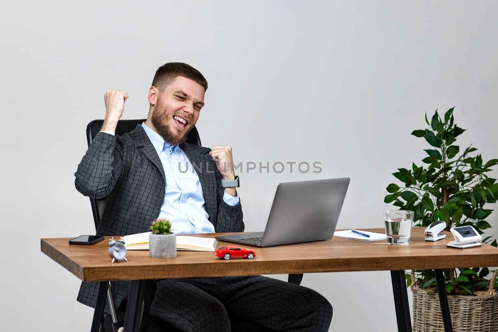 young man sitting on chair at table and resting, using laptop