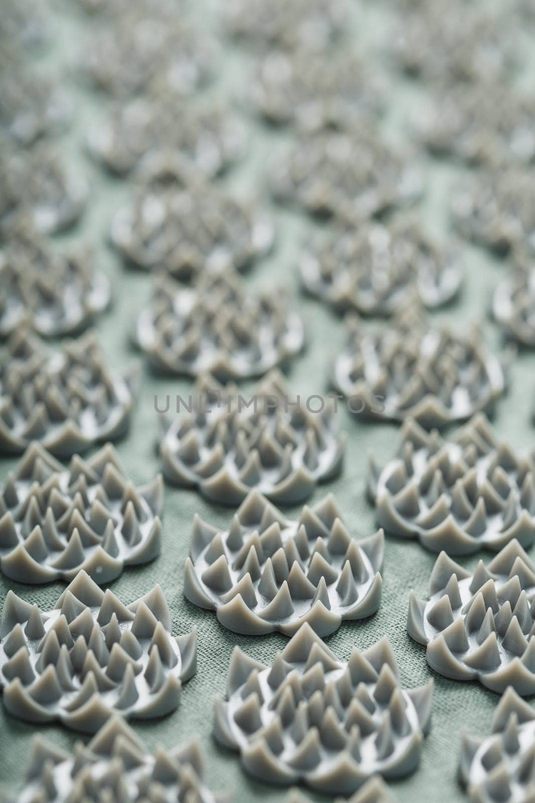 Sewing mother-of-pearl pins in a round white package on a blue background with free space