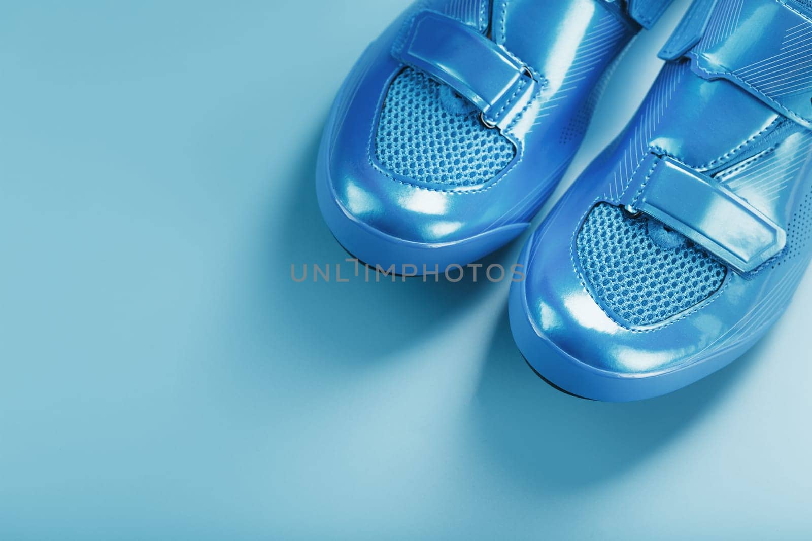 Blue Shiny Bicycle Shoes for Road Bike on Blue Background