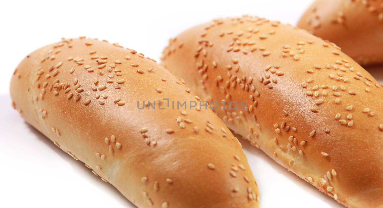 Bread baguettes with sesame seeds isolated on white background, white rustic Bakery food concept. Industrial baking bread made from white flour. Freshly organic baked bread.