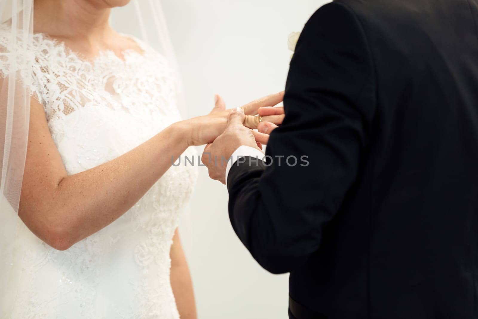 Wedding rings. Her Put the Wedding Ring on He. Close up Bride Put the Ring on Groom. thai wedding ceremony and thai wedding decoration. Bride Put the Ring on Groom's finger