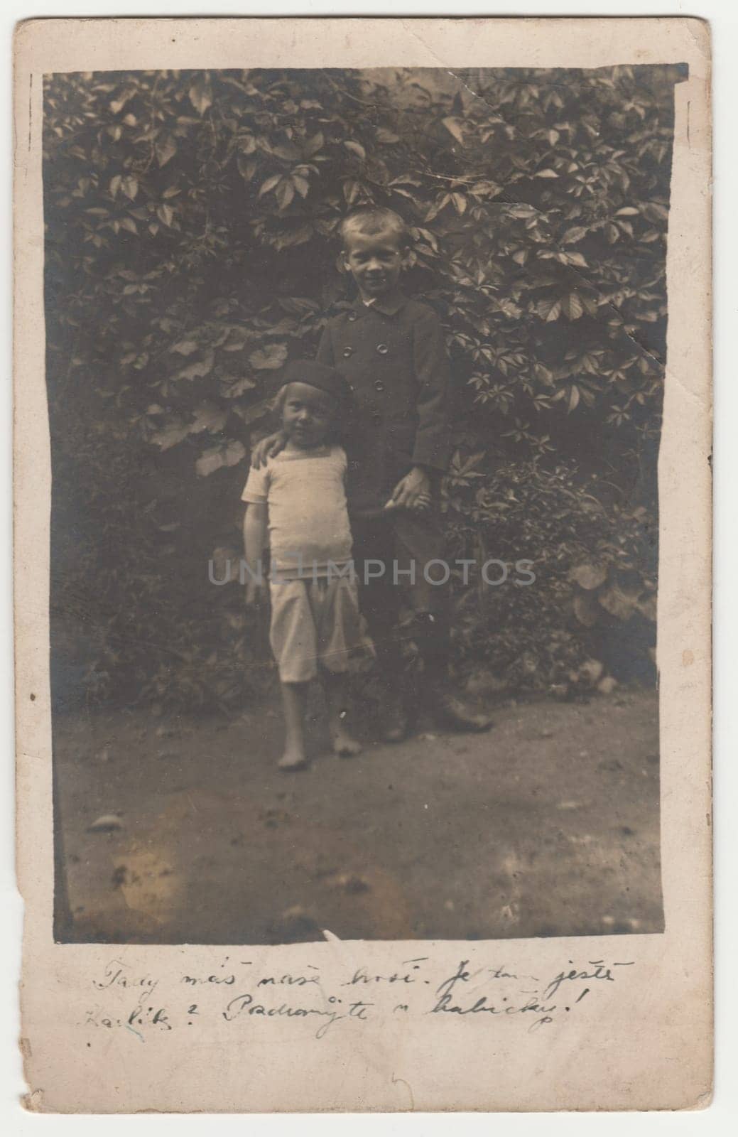 Vintage photo shows two boys - siblings outdoors. Retro black and white photography. Photo was taken in Austro-Hungarian Empire or also Austro-Hungarian Monarchy. Circa 1920s. by roman_nerud