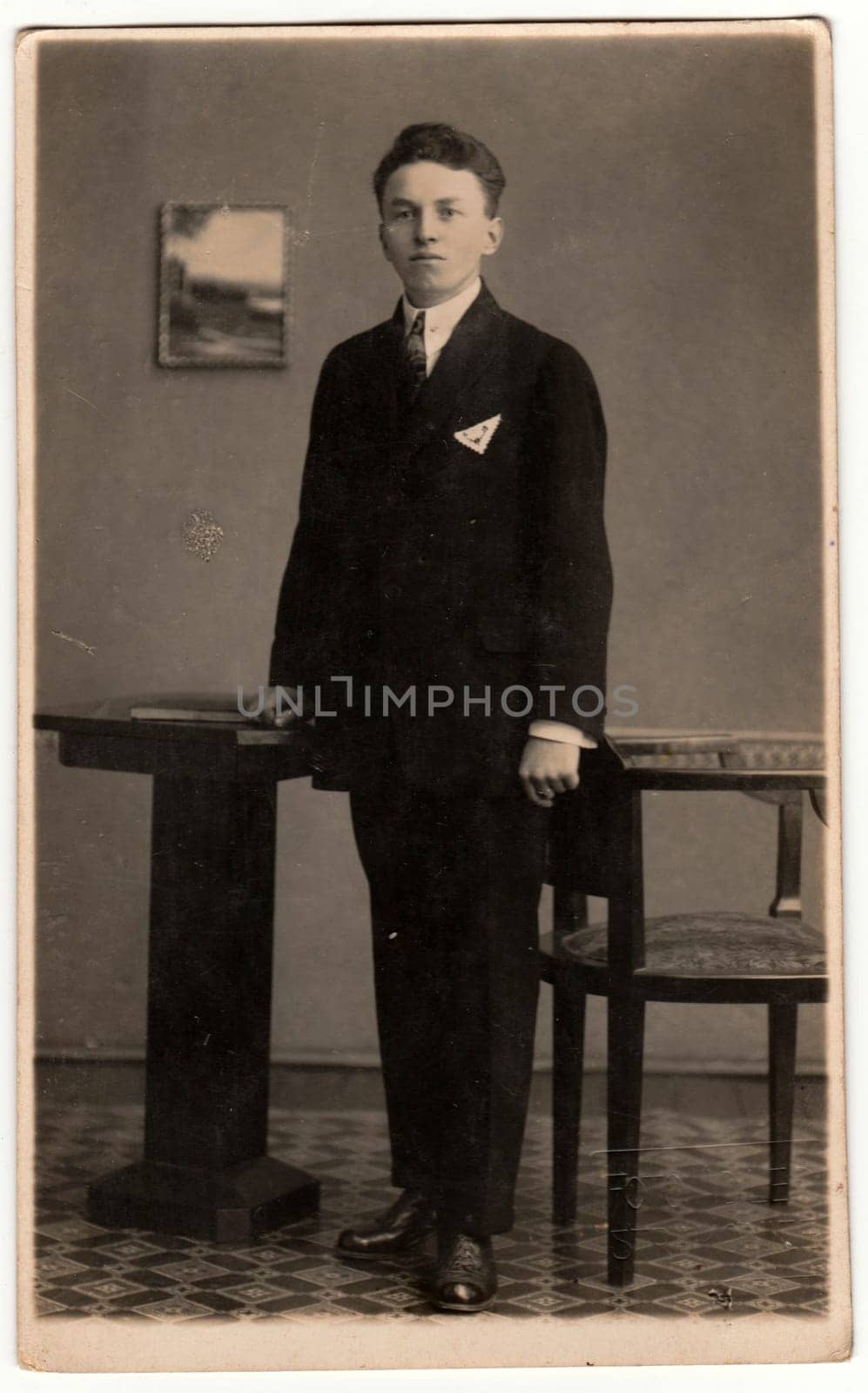 STRAKONICE, THE CZECHOSLOVAK REPUBLIC - CIRCA 1930s: Vintage photo shows young man poses in photography studio. Retro black and white photography. Circa 1930s.