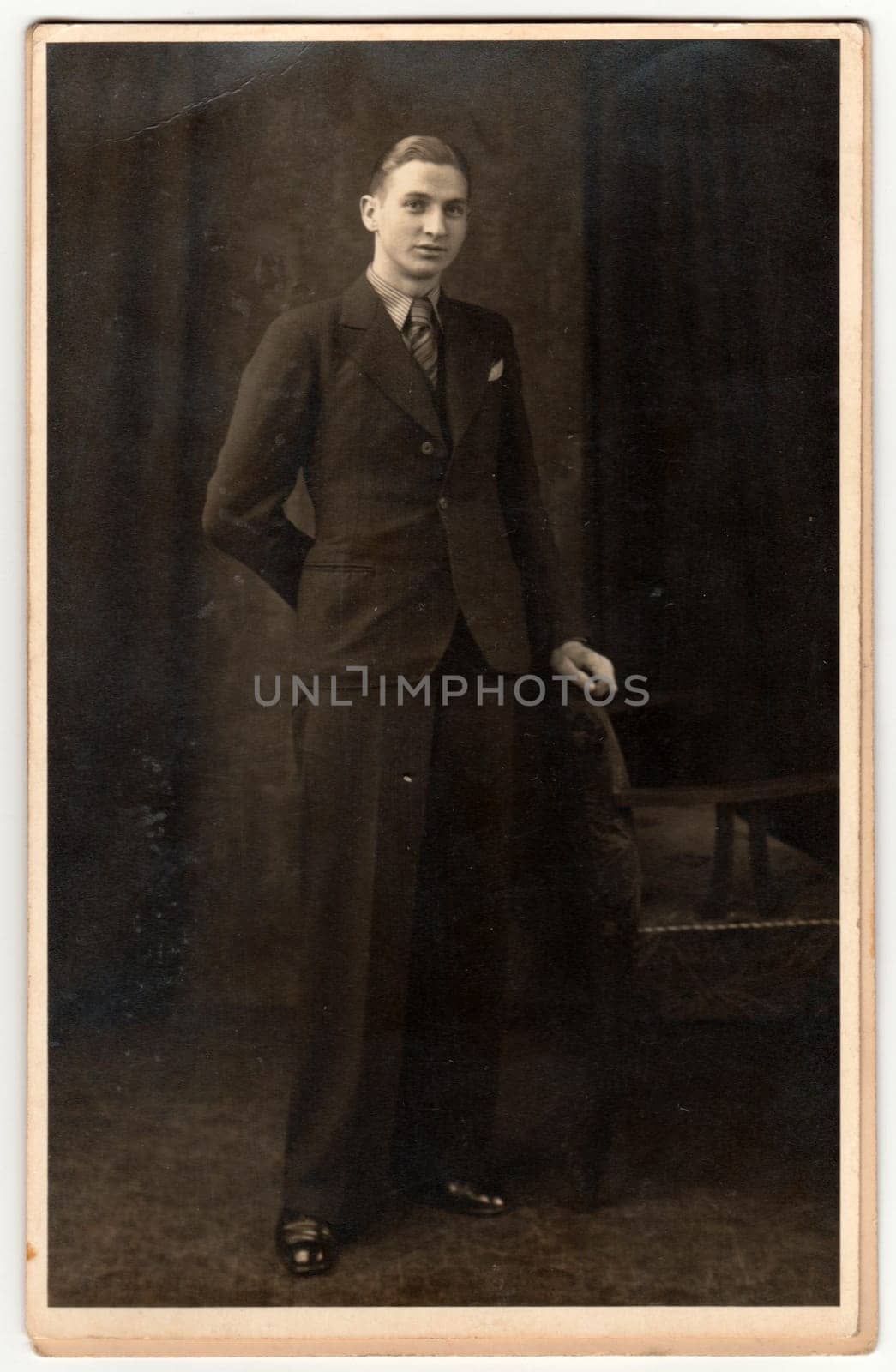 THE CZECHOSLOVAK REPUBLIC - CIRCA 1920s: Vintage photo shows young man poses in photography studio. Retro black and white photography. Circa 1920s.