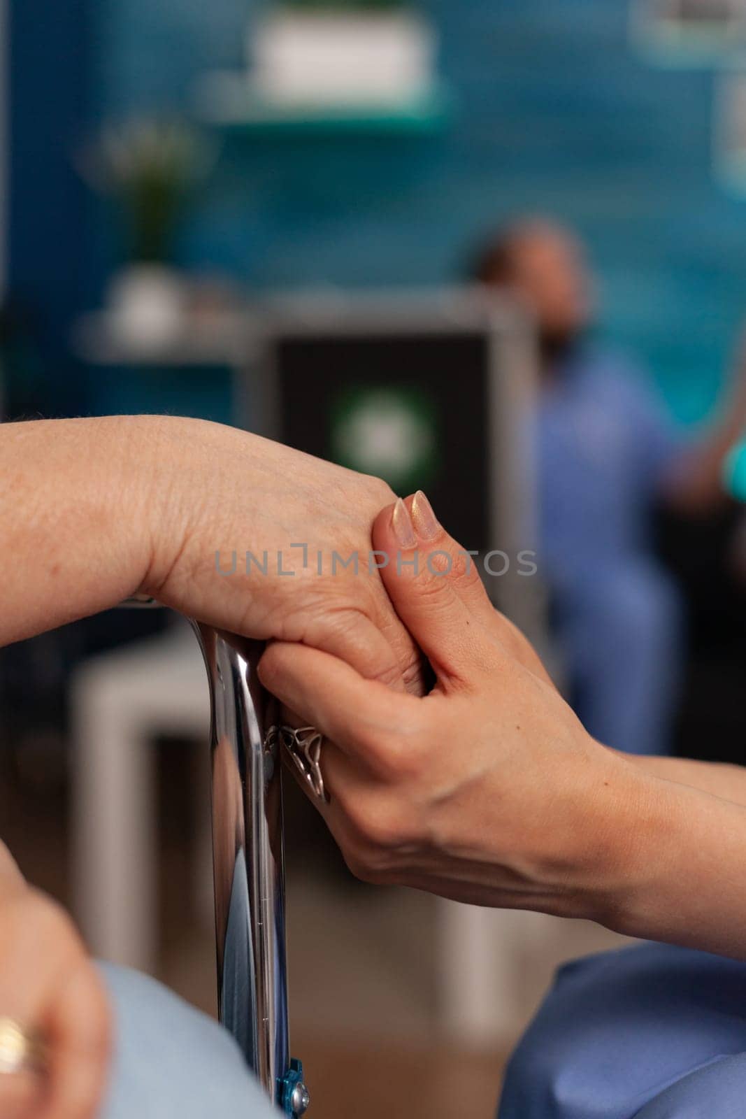 Nurse holding hand of senior female patient. by DCStudio