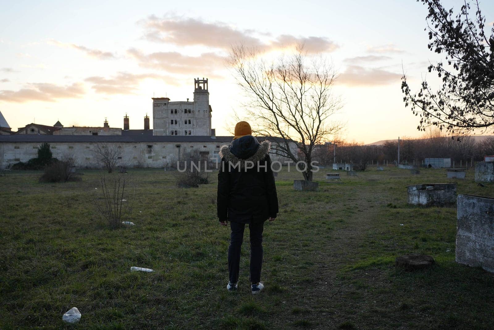 real slender man alone in front of scary building at an abandoned park. High quality photo
