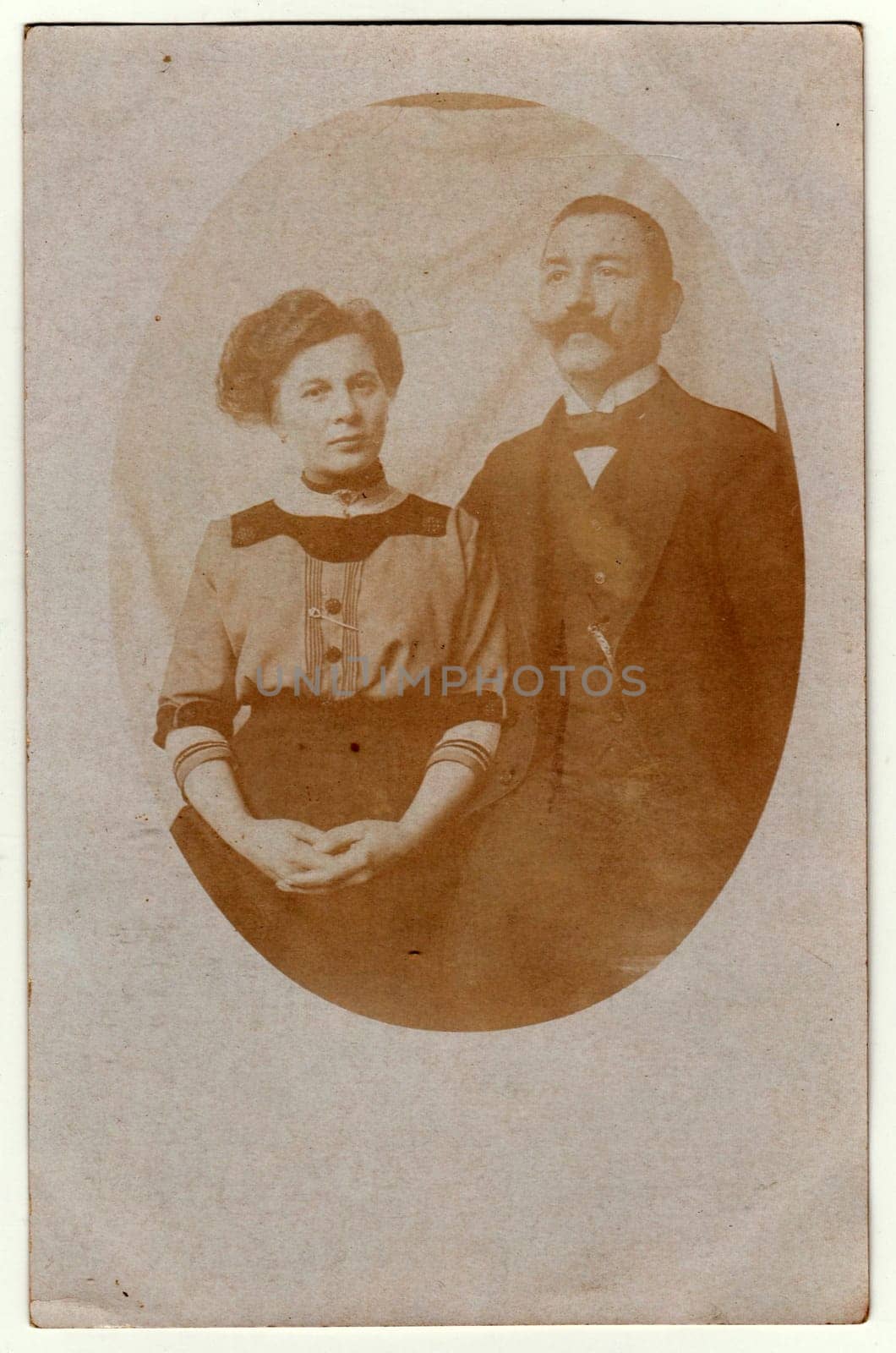 Vintage photo shows women and man - married couple. Retro black and white photography with sepia effect. Photo was taken in Austro-Hungarian Empire or also Austro-Hungarian Monarchy by roman_nerud