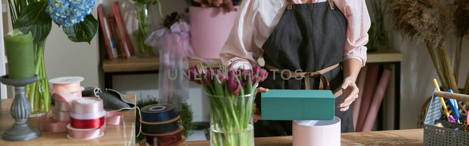 happy professional woman is working in flower shop