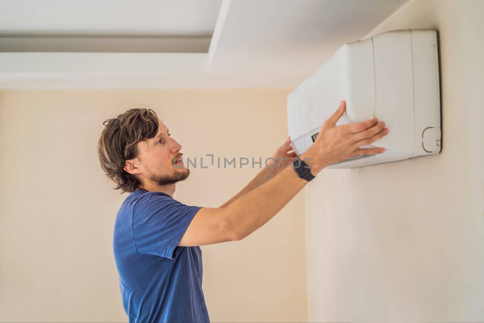 technician service removing air filter of the air conditioner for cleaning.