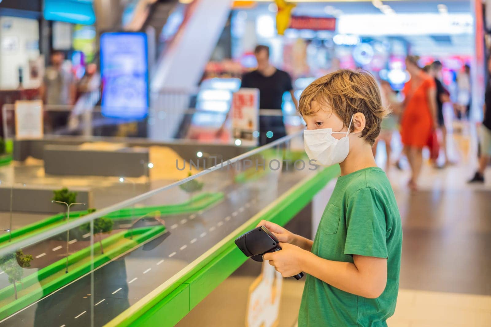 Adorable cute little child playing with toy on remote control, in the mall. Happy kid boy having fun. Leisure, lifestyle for kids concept.