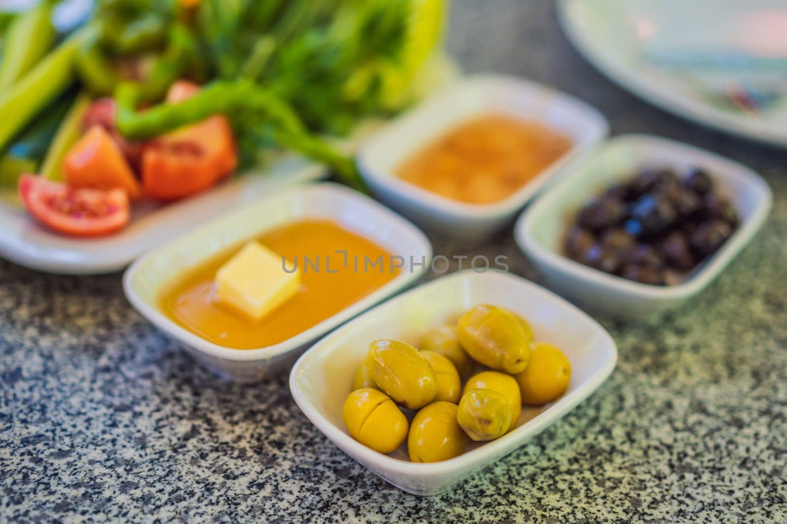 Turkish breakfast table. Pastries, vegetables, greens, olives, cheeses, fried eggs, spices, jams, honey, tea in copper pot and tulip glasses, wide composition by galitskaya