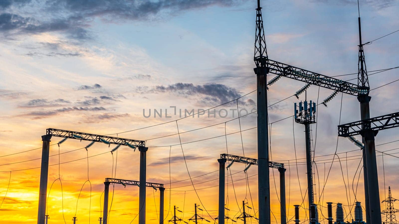 Production of fuel and electricity.Electrical networks with wires and transformers at sunset.Power transmission lines and from the power plant.Power lines with wires under voltage and electric current by YevgeniySam