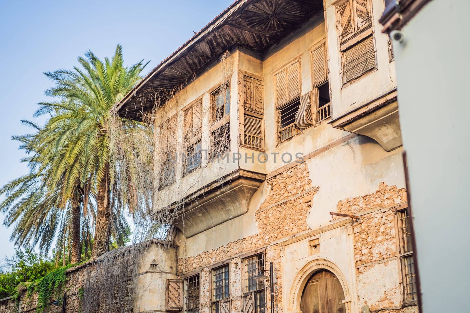 Woman tourist in Old town Kaleici in Antalya. Turkiye. Panoramic view of Antalya Old Town port, Taurus mountains and Mediterrranean Sea, Turkey.