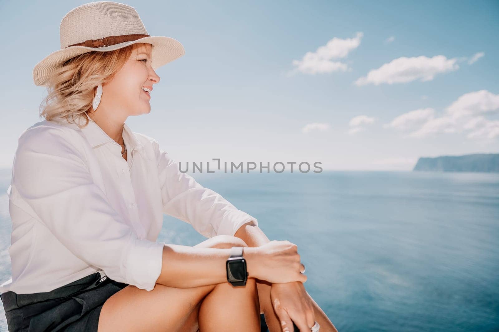 Woman sea laptop. Business woman in yellow hat freelancer with laptop working over blue sea beach. Girl relieves stress from work. Freelance, digital nomad, travel and holidays concept by panophotograph