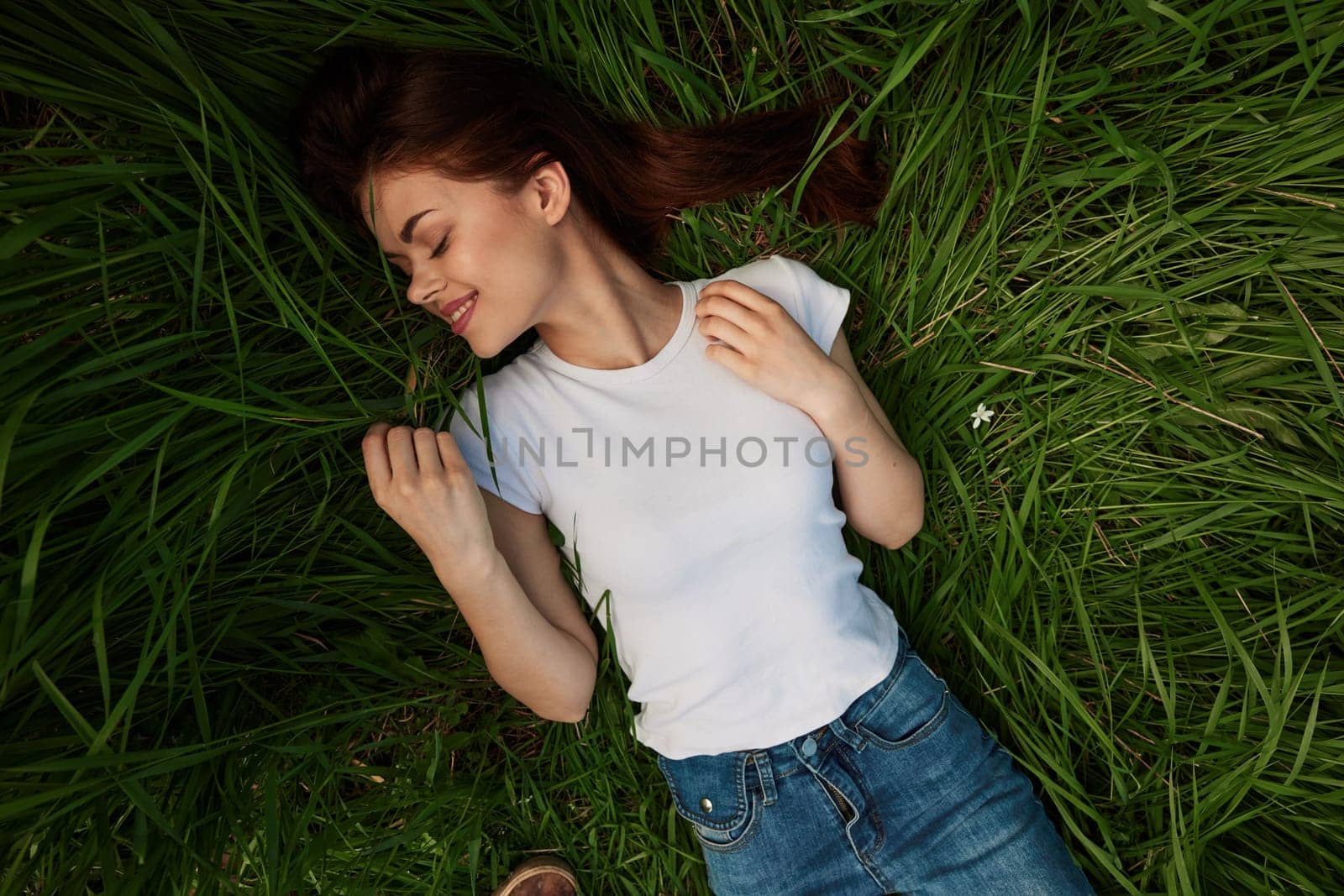 woman dreaming lying on the grass . High quality photo