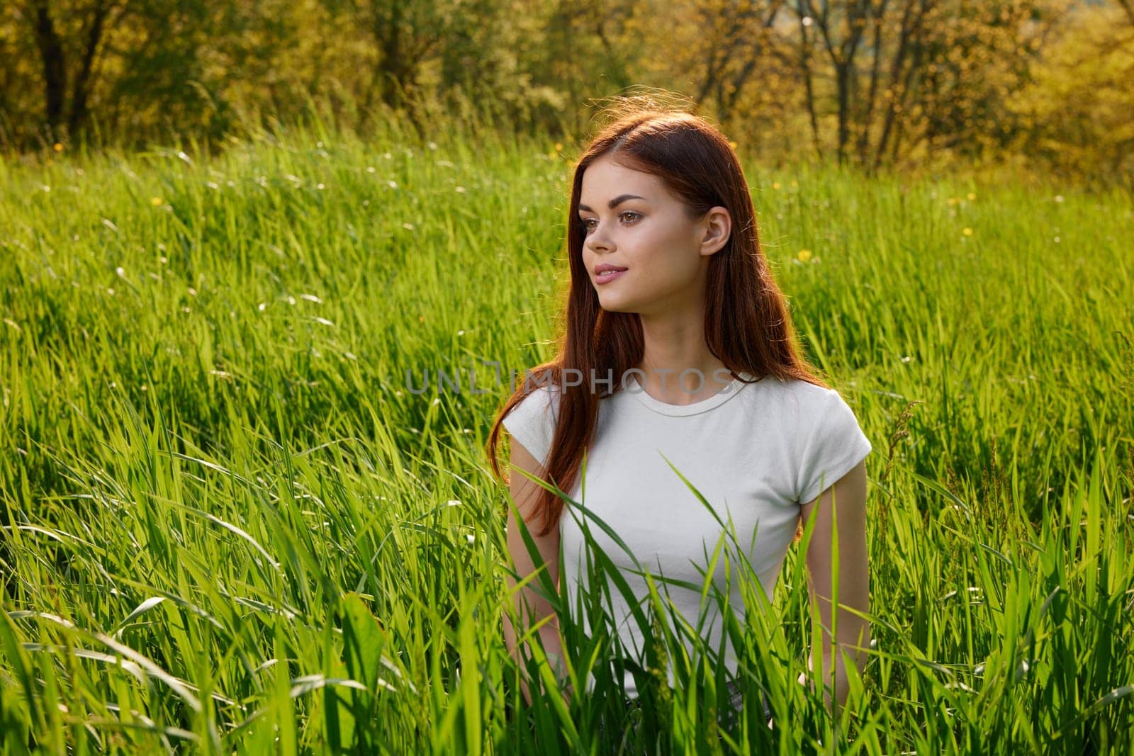happy cheerful woman laying in green grass by Vichizh