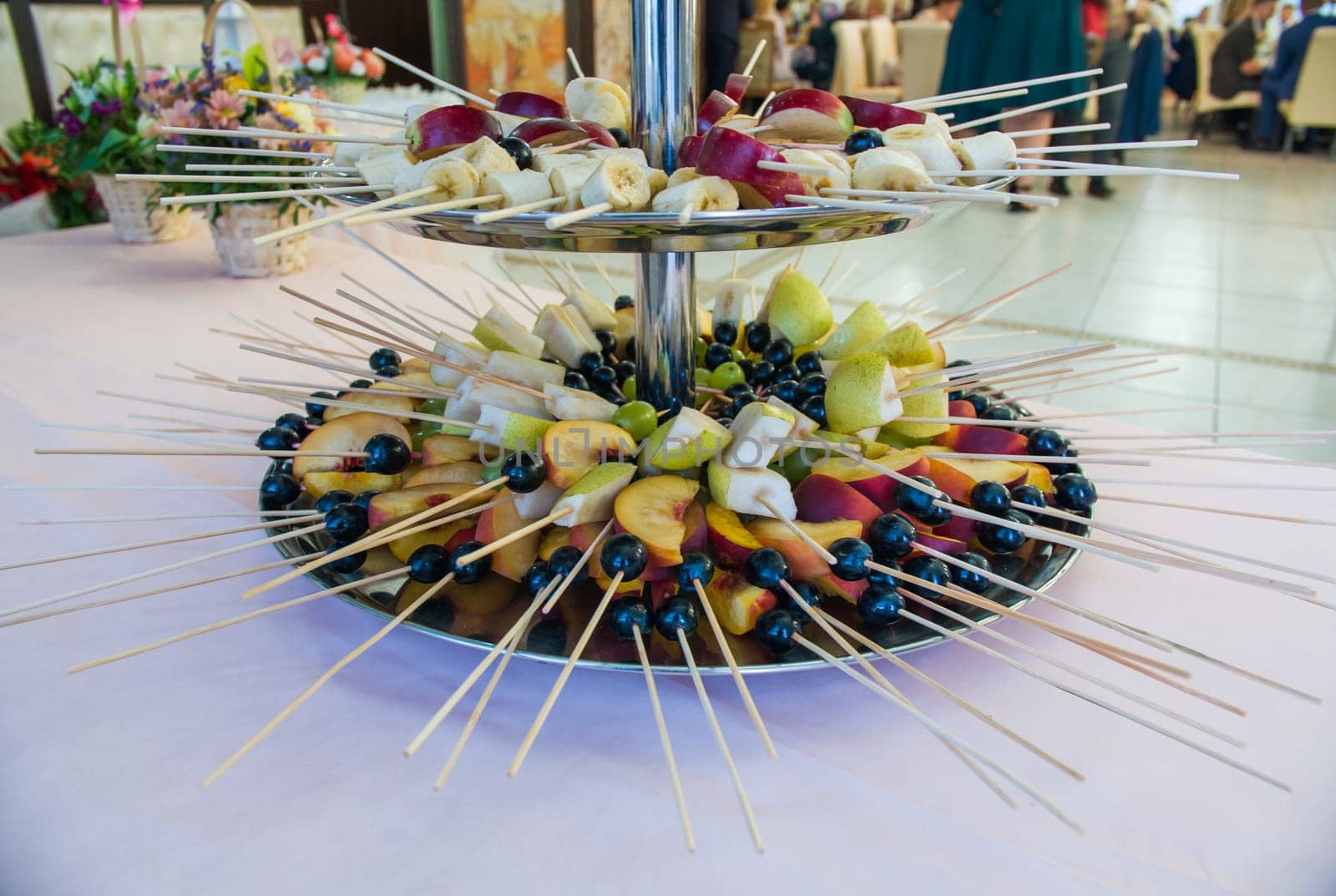 Fruit on a stick at a wedding celebration with light illumination
