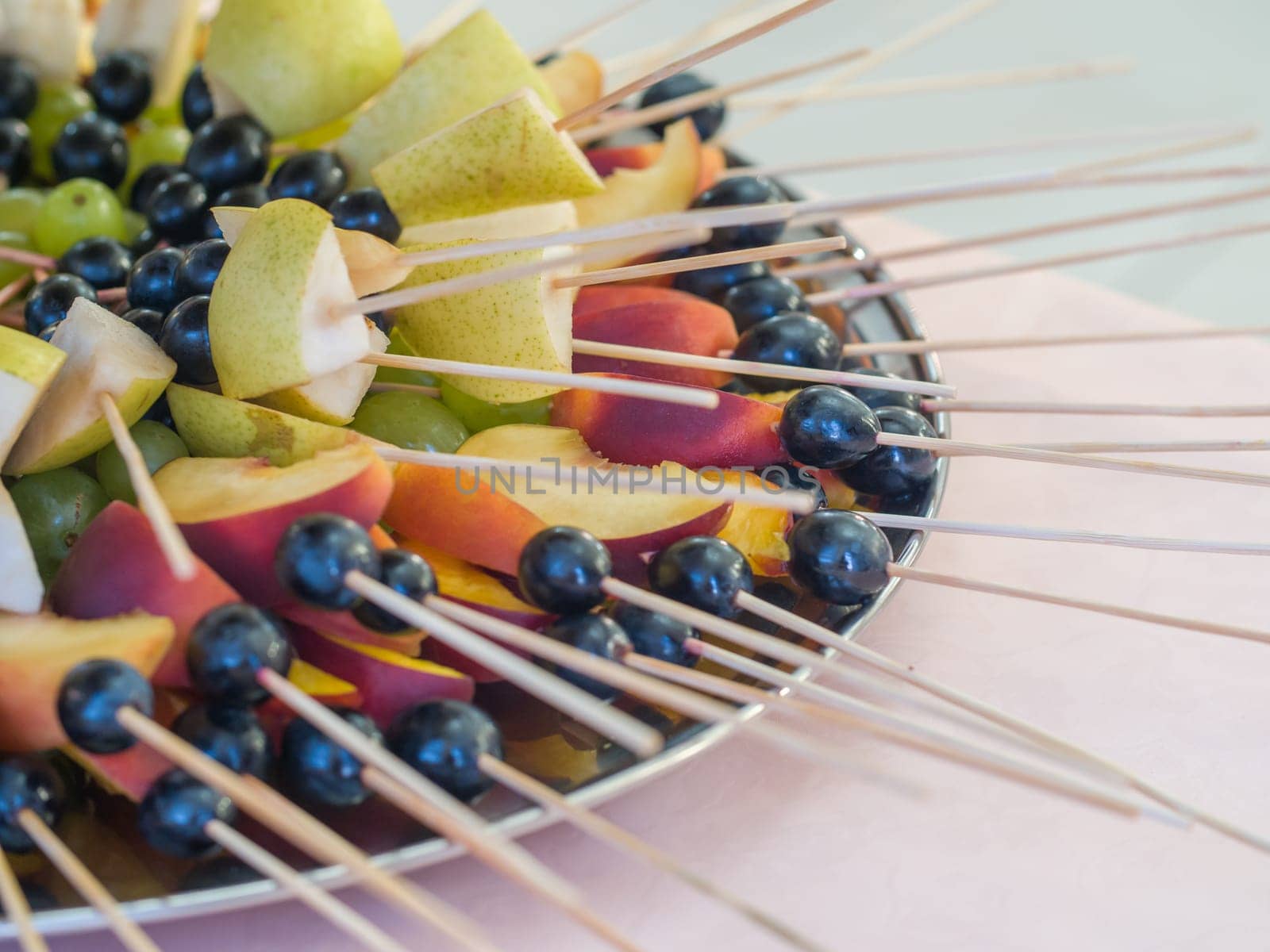 Fruit on a stick at a wedding celebration with light illumination