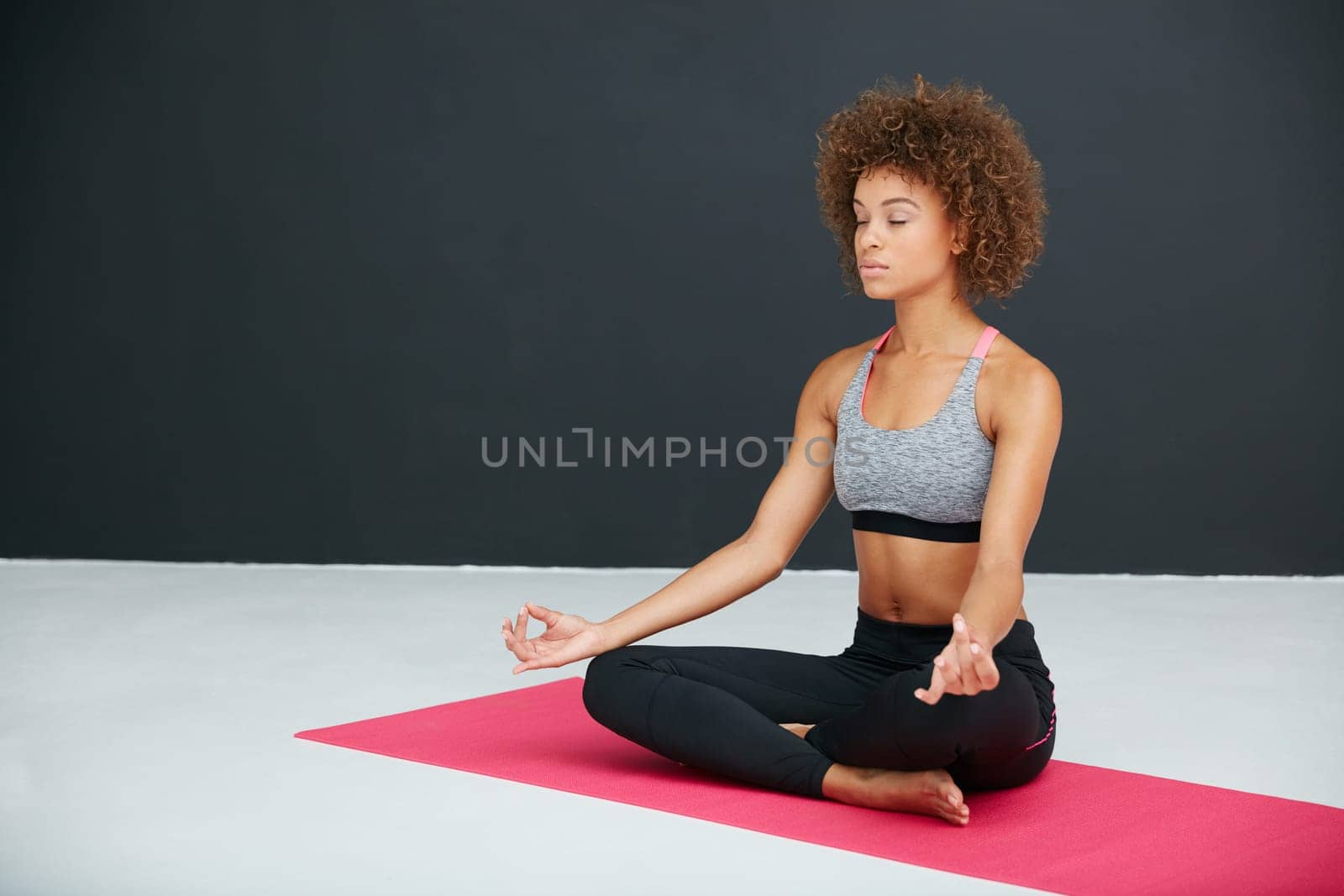 Yoga doesnt take time, it gives time. a young woman practising yoga in a studio