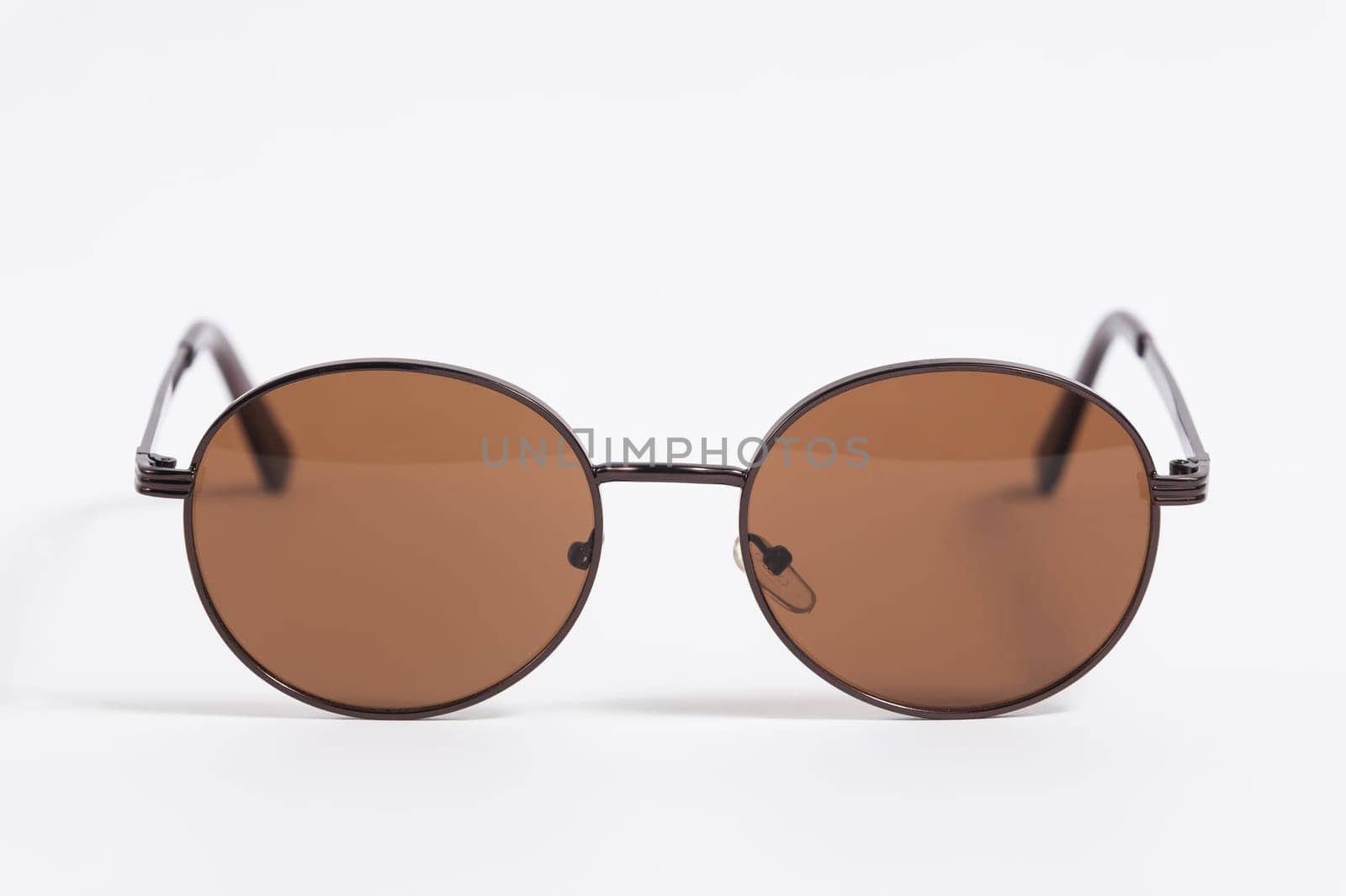 Brown sunglasses isolated on white background close-up, fashionable trendy stylish accessory.