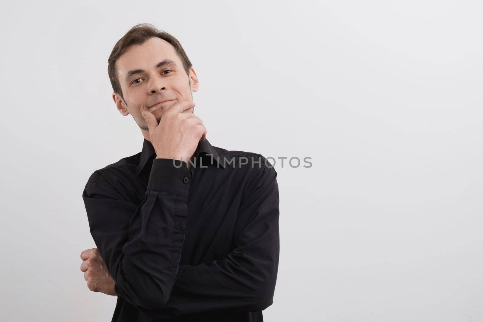Caucasian man 30s in a black shirt portrait on white background.