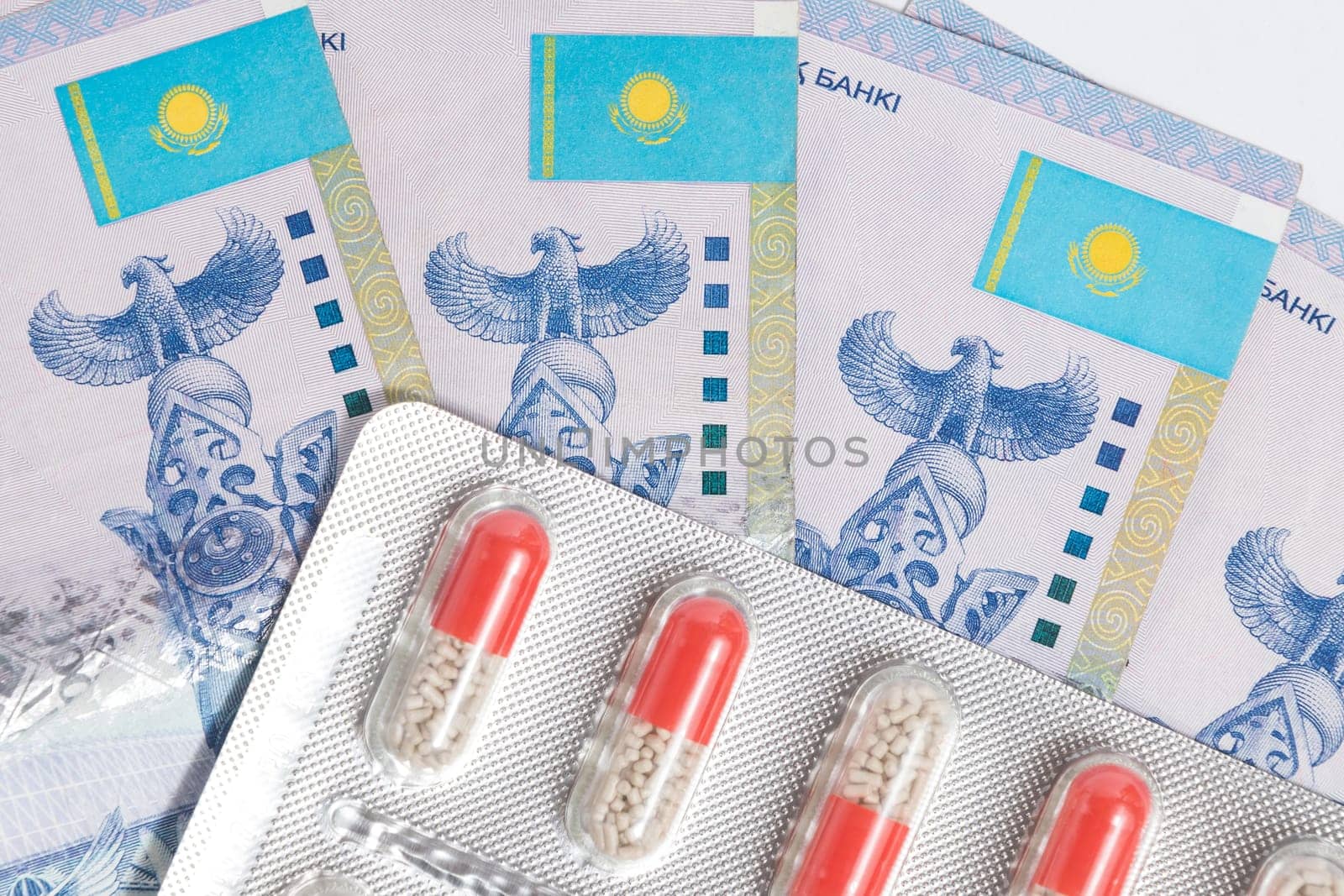 Top view on blister with medical pills drug with Tenge Kazakhstan money.