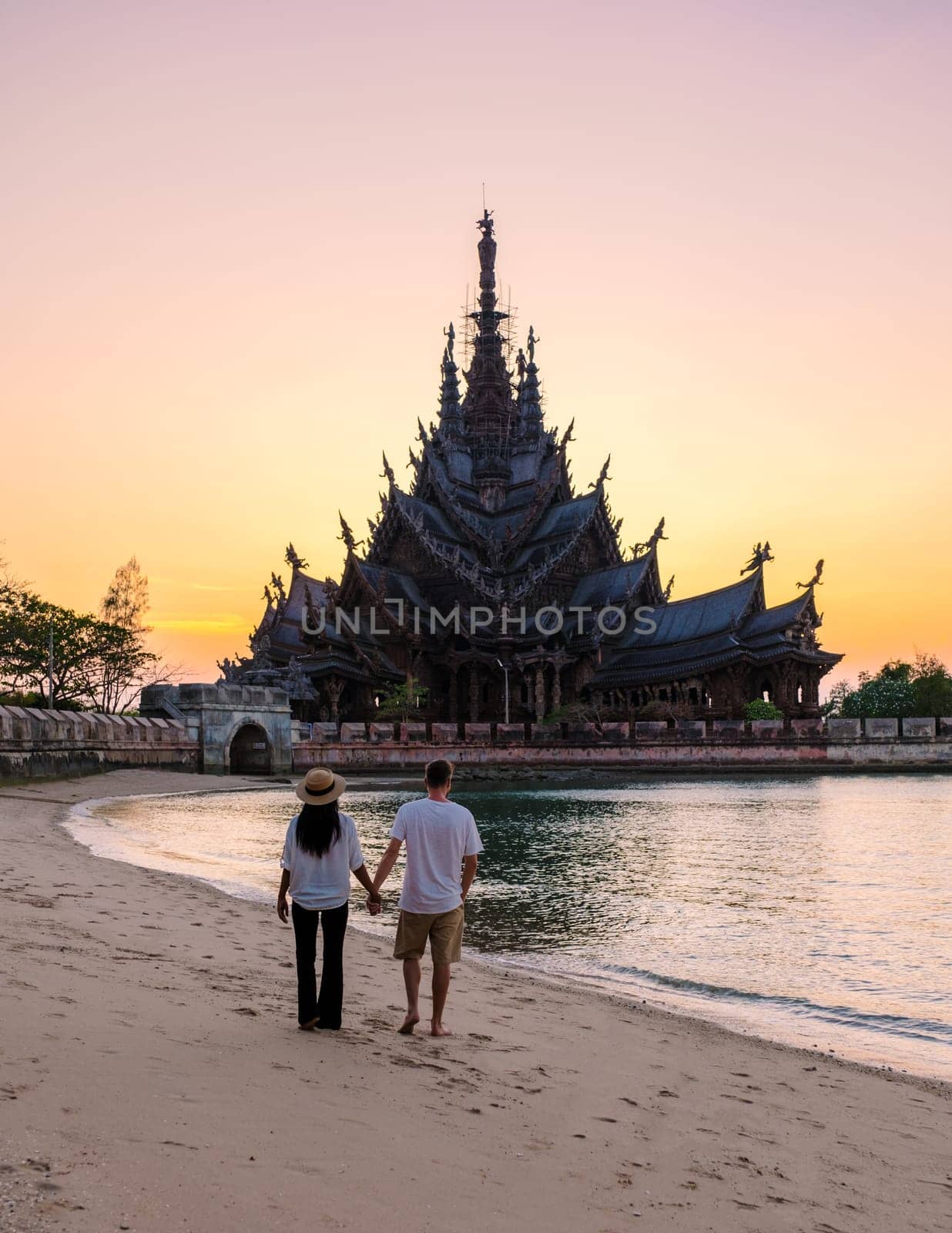 Sanctuary of Truth, Pattaya, Thailand, wooden temple by the ocean at sunset on the beach of Pattaya by fokkebok