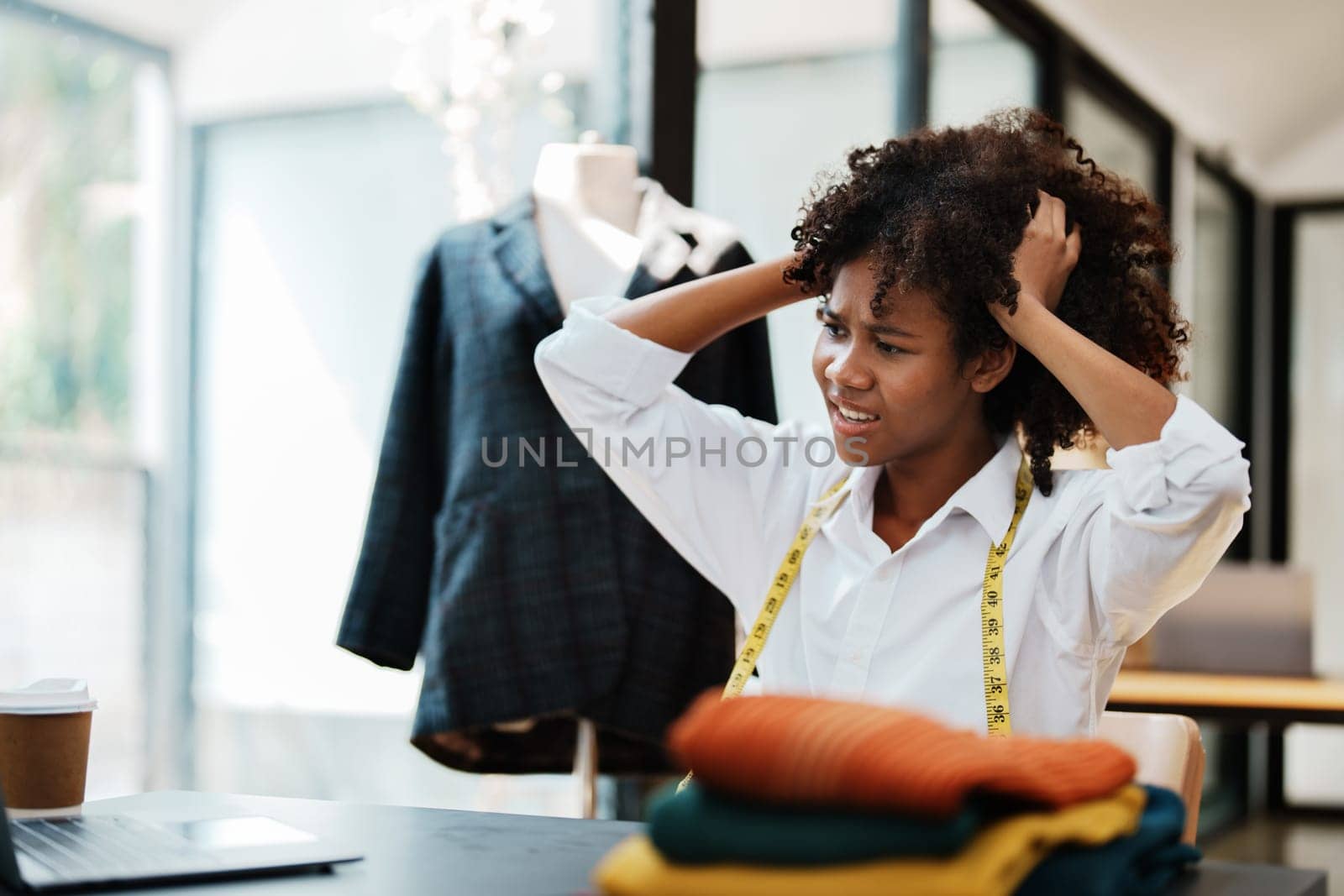 young teen african american fashion designer stylish burnout working at fashion Business studio.