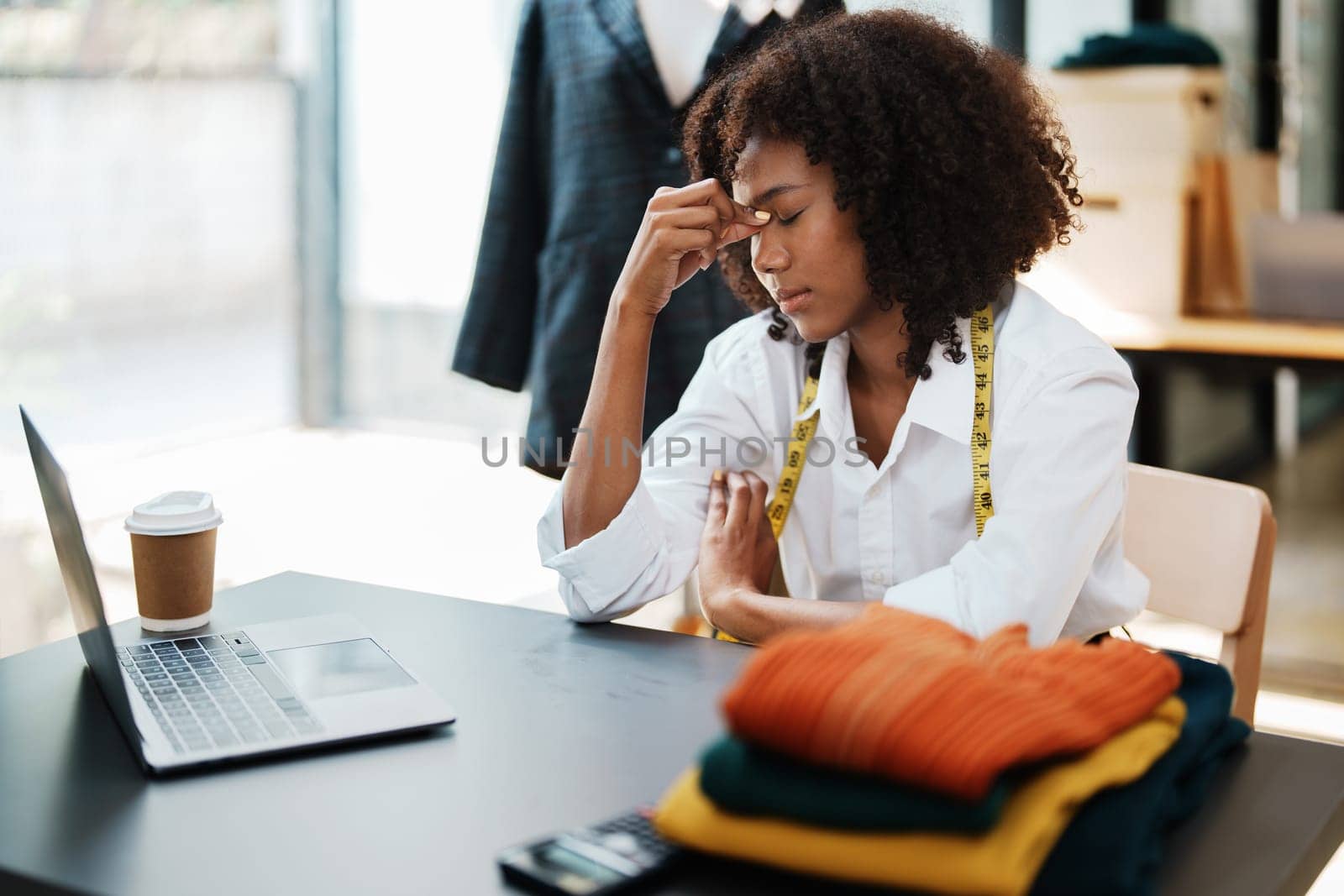 young teen african american fashion designer stylish burnout working at fashion Business studio.