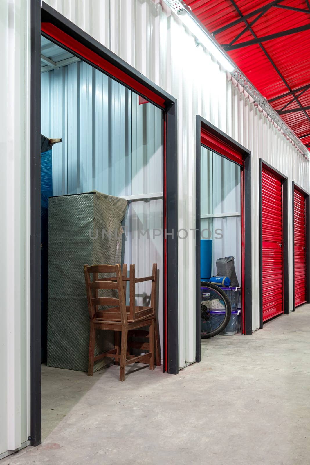 Corridor of self storage unit with red doors. Rental Storage Units by Sonat