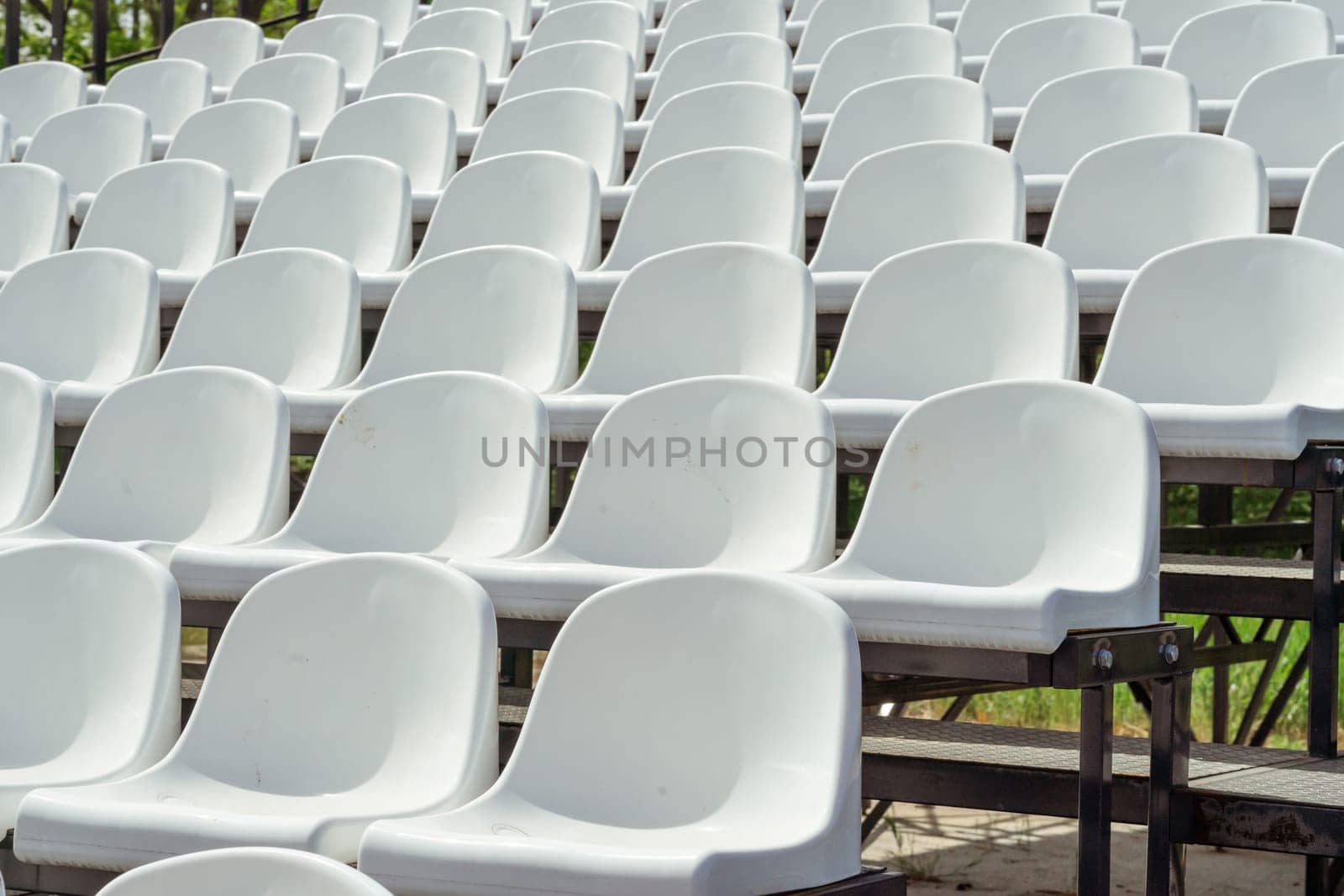 Seats of tribune on sport stadium. Concept of fans, chairs for audience, cultural environment concept. mpty seats, modern stadium