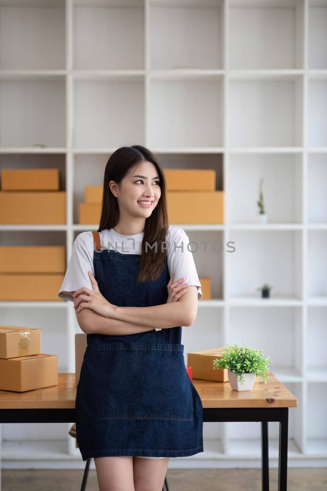 Starting Small business entrepreneur SME freelance, Portrait young woman working at home office, BOX, smartphone, laptop, online, marketing, packaging, delivery, b2b, SME, e-commerce concept.. by wichayada