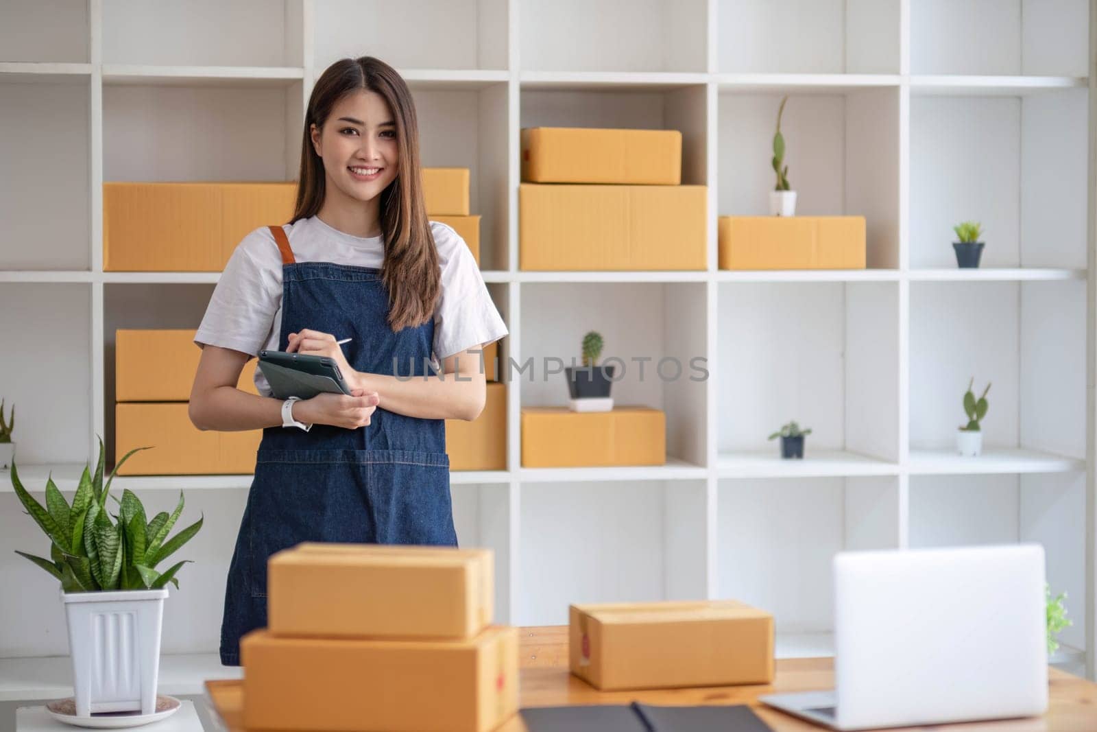 Starting Small business entrepreneur SME freelance, Portrait young woman working at home office, BOX, smartphone, laptop, online, marketing, packaging, delivery, b2b, SME, e-commerce concept